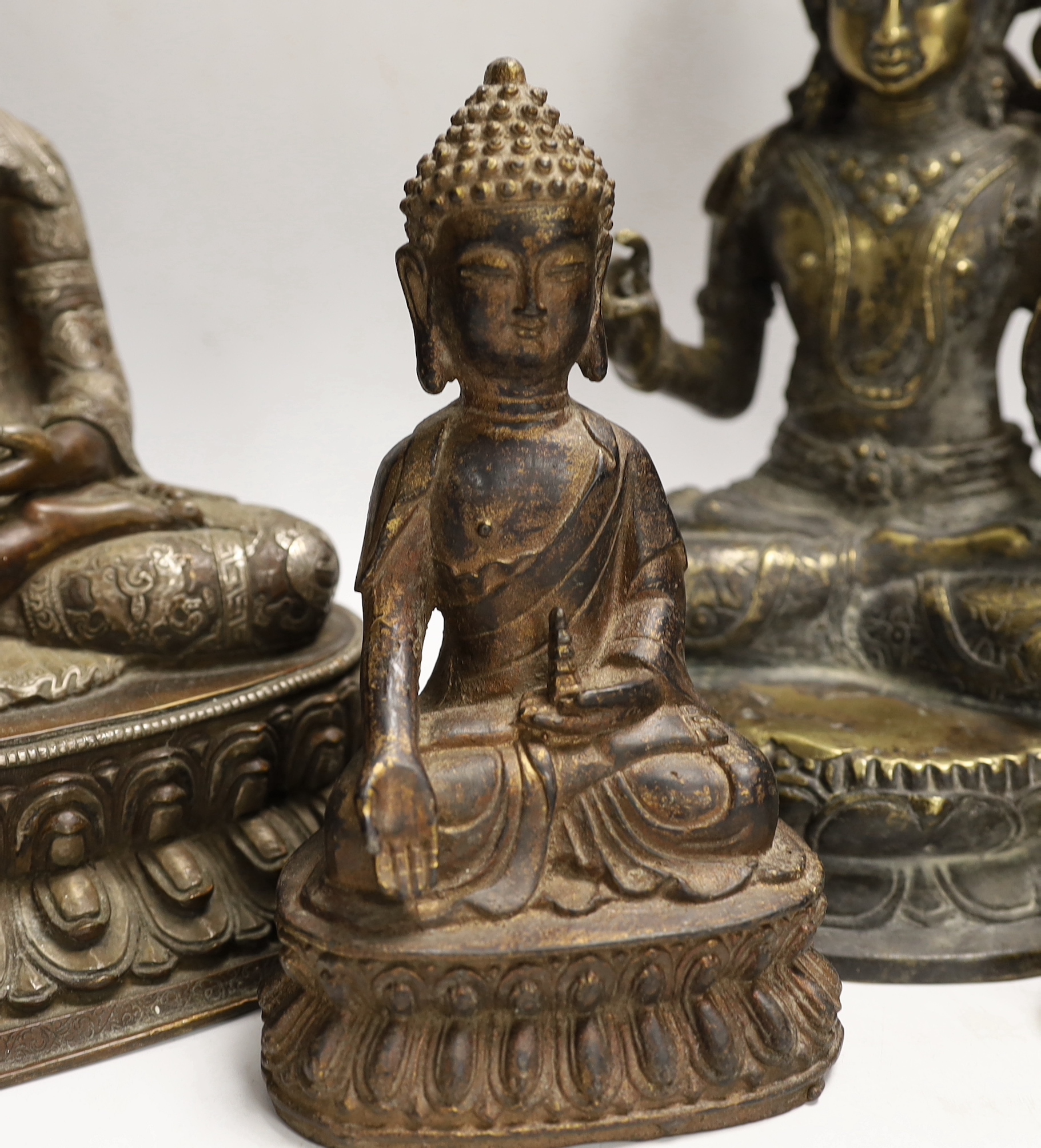 Four Thai and far-eastern bronze figures of the Buddha, tallest 28cm